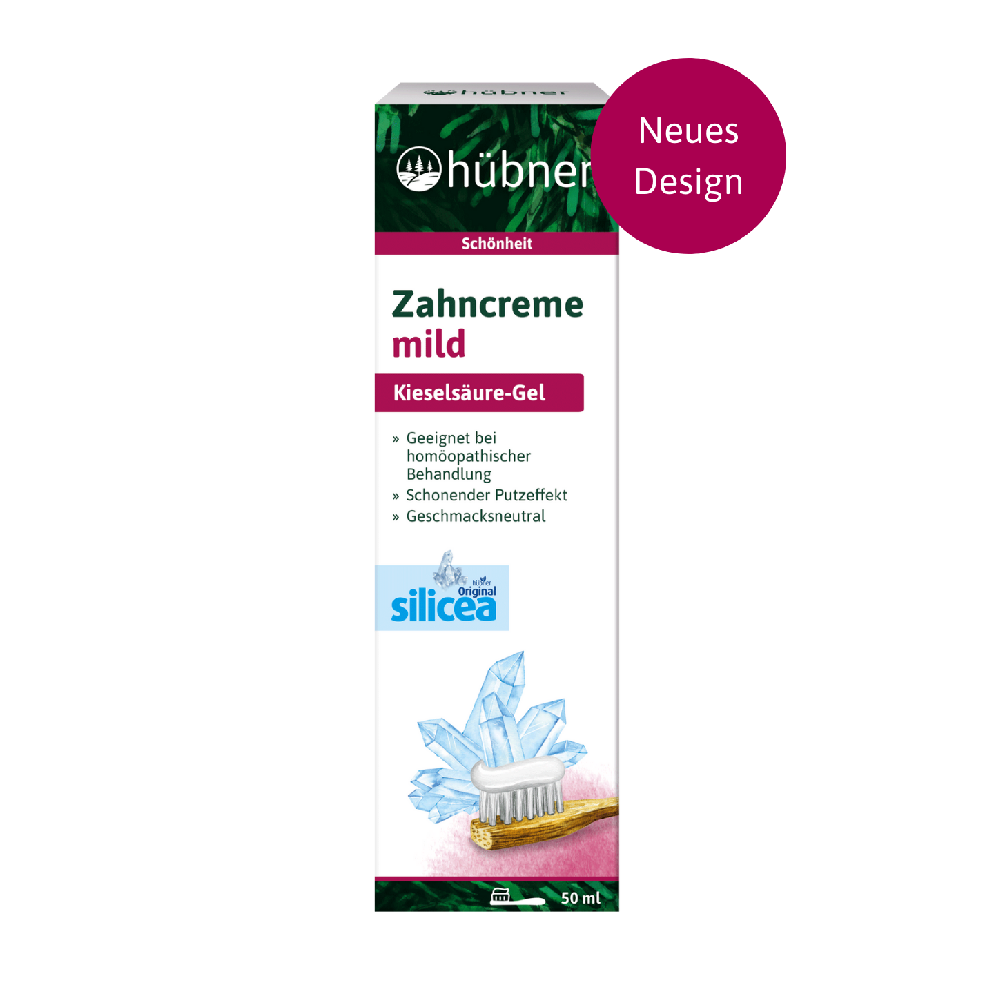 Eine Schachtel milde Zahnpasta Hübner Zahncreme mit blauen Kristallen und eine Zahnbürste mit einem Neues Design-Etikett.